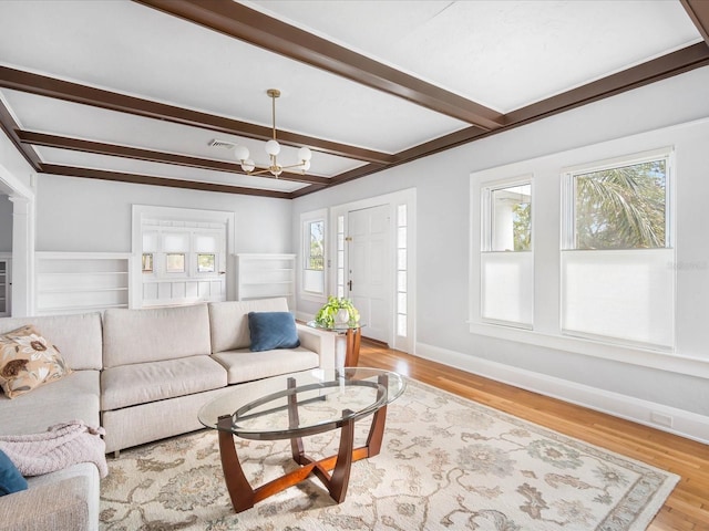 living room featuring light hardwood / wood-style floors, plenty of natural light, and a notable chandelier