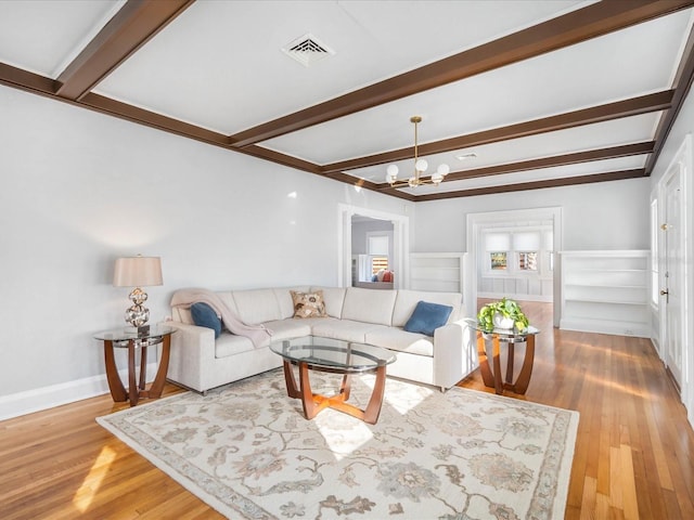 living room with beamed ceiling, hardwood / wood-style floors, and an inviting chandelier