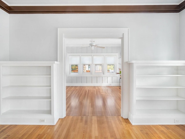 corridor featuring light hardwood / wood-style floors and crown molding