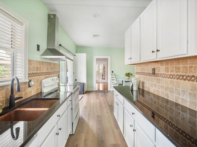 kitchen featuring ventilation hood, white cabinets, sink, dark stone countertops, and white range with electric stovetop