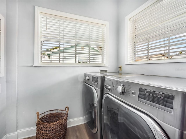 laundry area with a healthy amount of sunlight, washer and dryer, and wood-type flooring