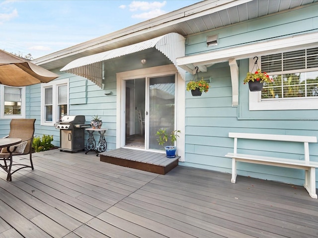 wooden terrace featuring area for grilling