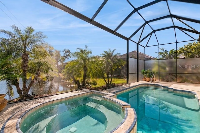 view of swimming pool featuring a lanai and an in ground hot tub