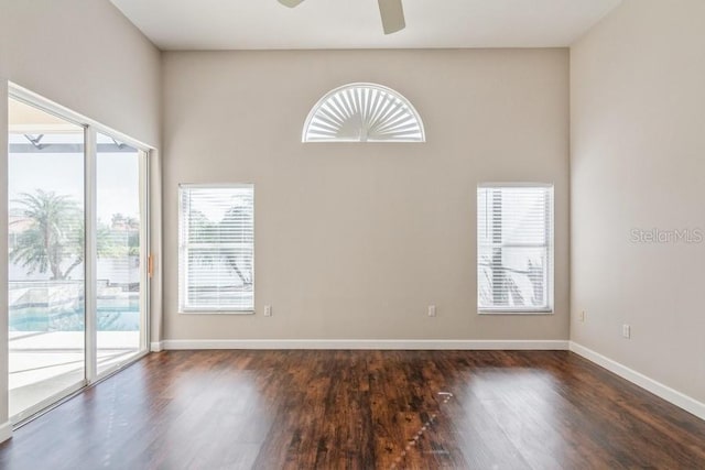 spare room featuring dark hardwood / wood-style flooring and ceiling fan