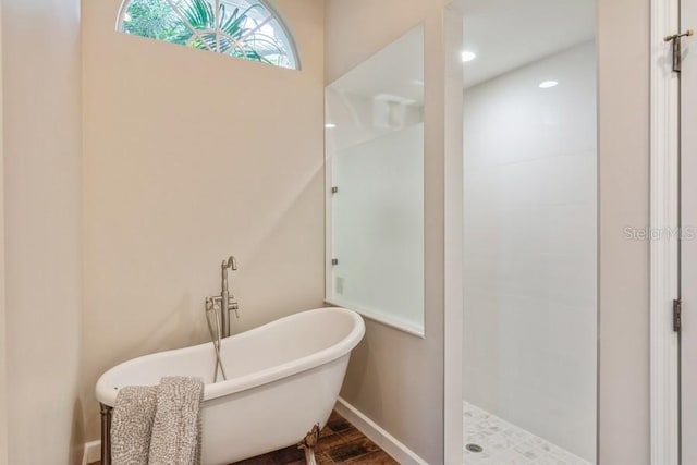 bathroom with separate shower and tub