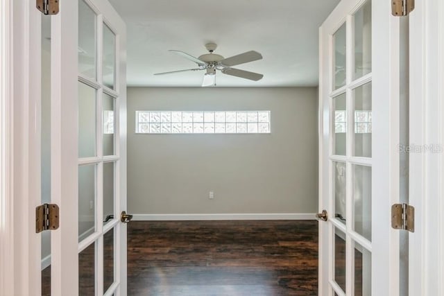 empty room featuring french doors, dark hardwood / wood-style floors, and ceiling fan