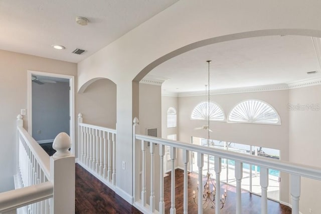 hall featuring dark hardwood / wood-style flooring, crown molding, and a healthy amount of sunlight