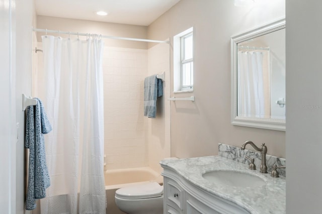 full bathroom featuring vanity, shower / bath combo, and toilet