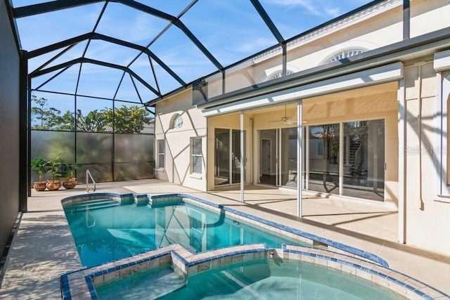 view of swimming pool featuring ceiling fan, a patio area, a lanai, and an in ground hot tub