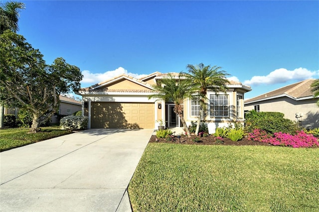 view of front of home with a garage and a front lawn