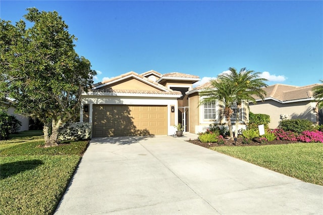 view of front of home featuring a front lawn and a garage