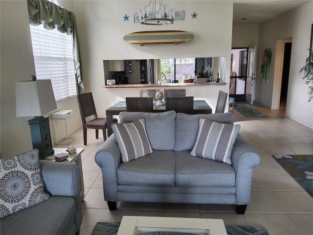 tiled living room featuring sink and a chandelier