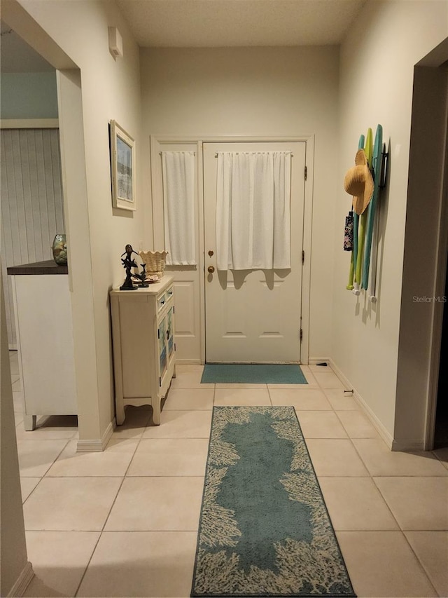 doorway with light tile patterned floors