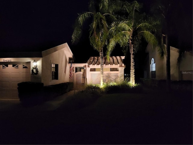 property exterior at twilight featuring a garage