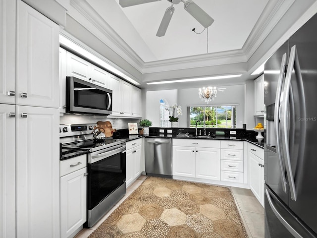 kitchen featuring kitchen peninsula, sink, white cabinets, and stainless steel appliances