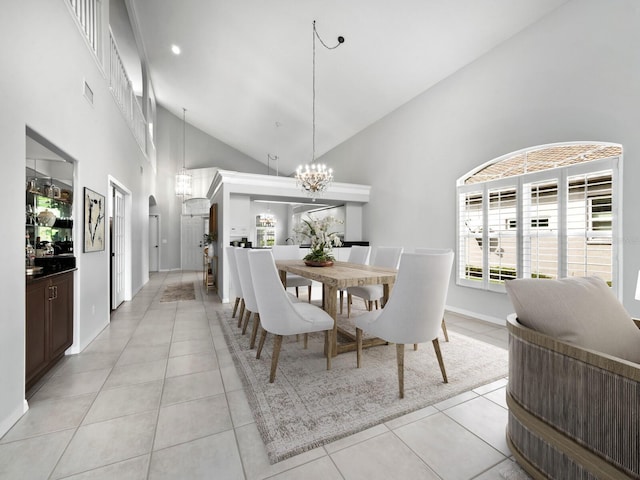 dining room with light tile patterned floors, an inviting chandelier, and high vaulted ceiling