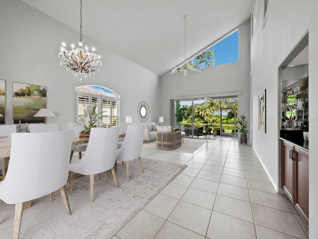 tiled dining area with high vaulted ceiling and a chandelier