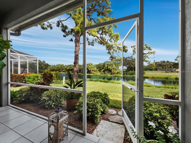 sunroom / solarium featuring a water view