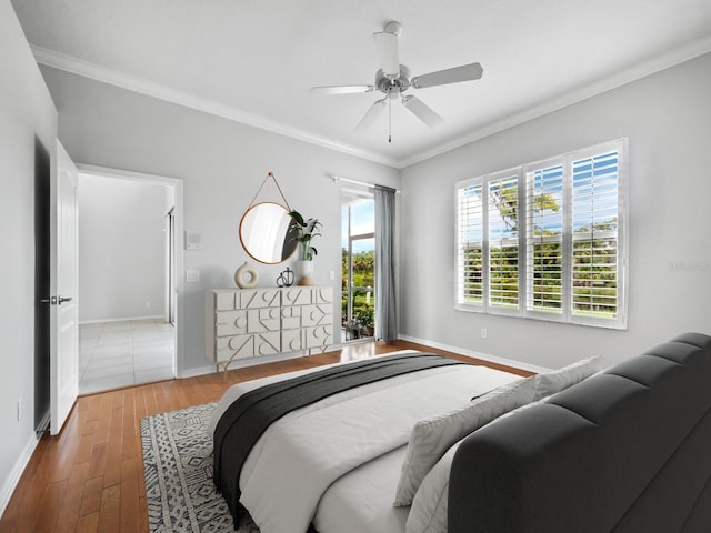 bedroom with hardwood / wood-style floors, ceiling fan, and ornamental molding