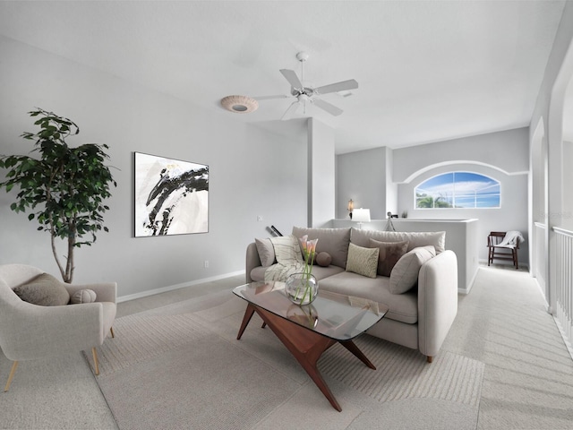 carpeted living room with ceiling fan