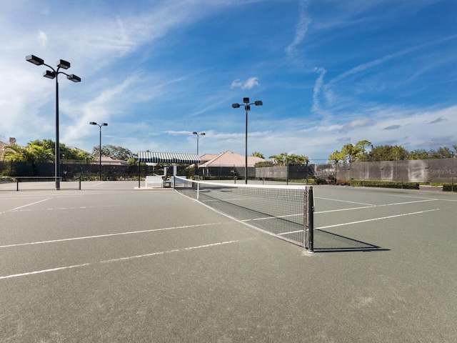 view of tennis court with basketball hoop