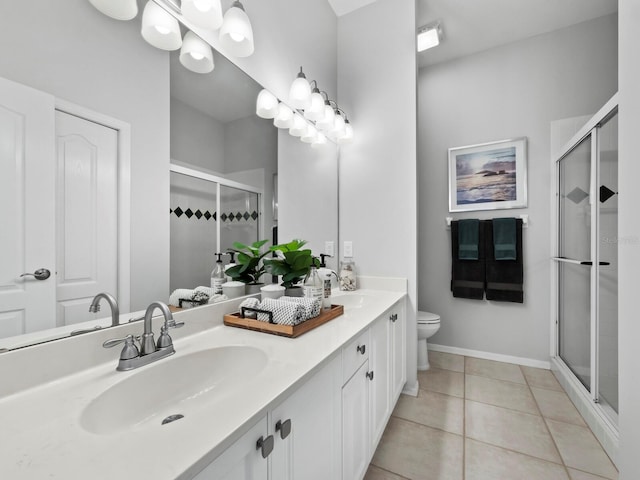 8737 Pebble Creek Ln, Sarasota, FL 34238 - full bathroom featuring double vanity, toilet, a stall shower, tile patterned floors, and baseboards