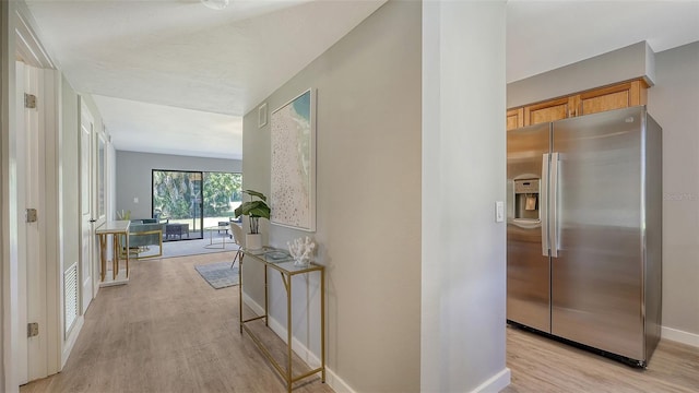 hall with light hardwood / wood-style flooring