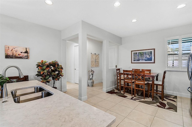 tiled dining room featuring sink