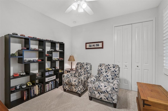 sitting room with carpet flooring and ceiling fan