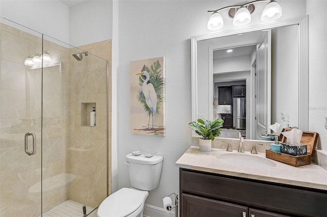 bathroom featuring vanity, toilet, and an enclosed shower