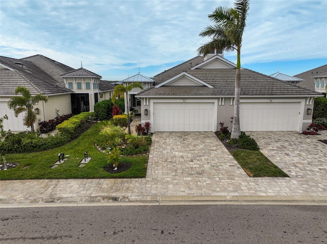 view of front of property featuring a garage and a front lawn