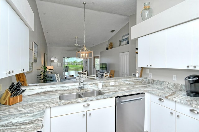 kitchen featuring white cabinets, sink, vaulted ceiling, stainless steel dishwasher, and kitchen peninsula