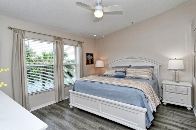 bedroom featuring a textured ceiling, ceiling fan, and dark wood-type flooring