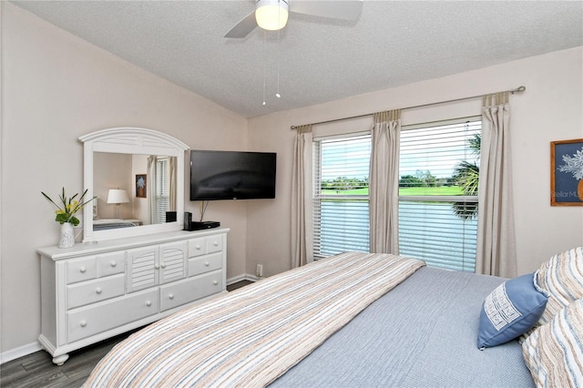 bedroom with a textured ceiling, ceiling fan, and dark wood-type flooring