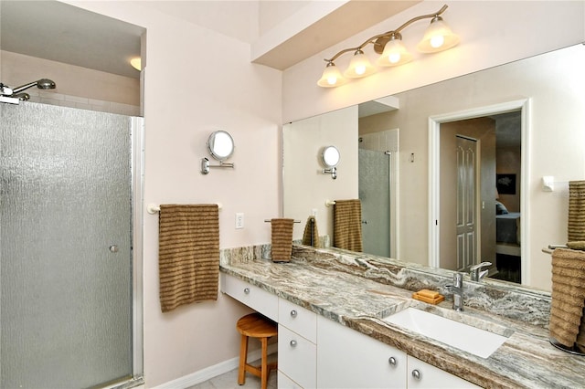 bathroom with vanity and a shower with door