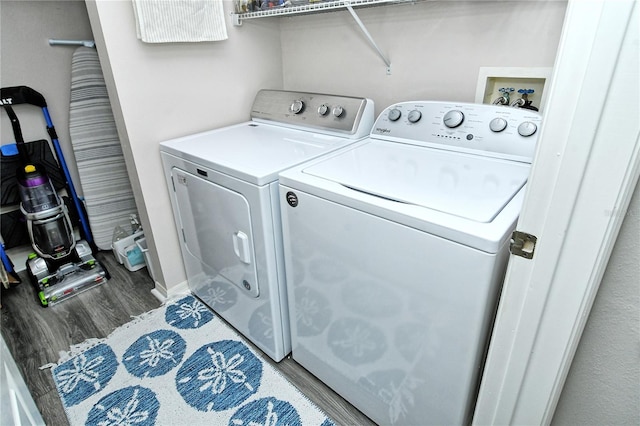 laundry room featuring hardwood / wood-style flooring and independent washer and dryer