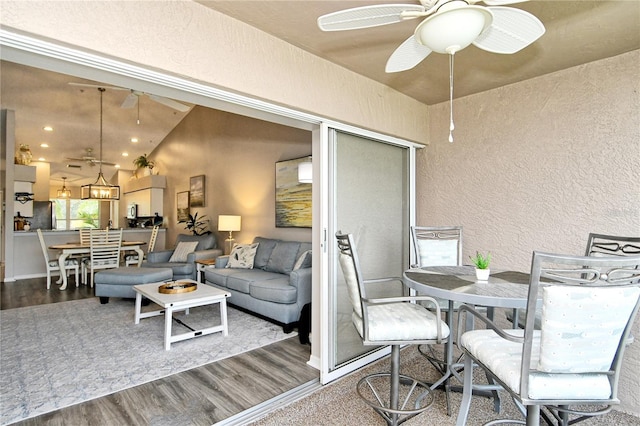 interior space featuring hardwood / wood-style floors, ceiling fan, and lofted ceiling