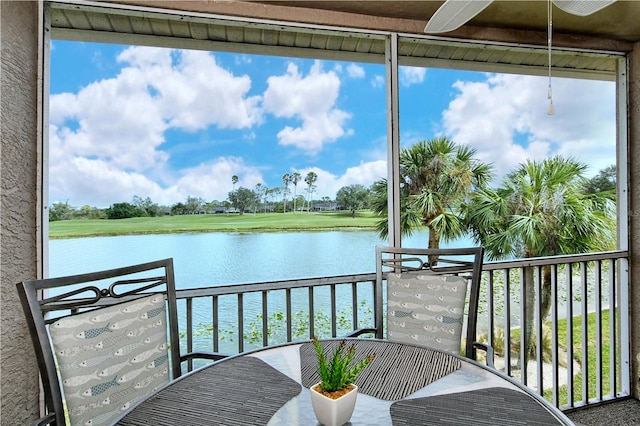 sunroom / solarium with a water view