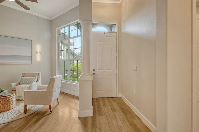 entryway featuring ceiling fan, crown molding, and light hardwood / wood-style flooring