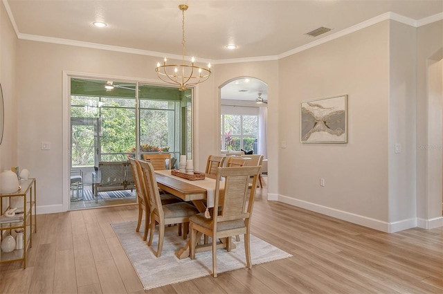 dining space featuring ceiling fan with notable chandelier, ornamental molding, and light hardwood / wood-style floors