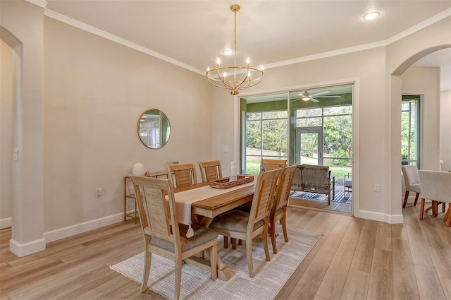 dining area featuring crown molding, ceiling fan with notable chandelier, and light hardwood / wood-style flooring