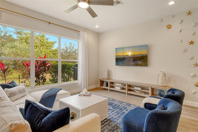 living room with light wood-type flooring and ceiling fan