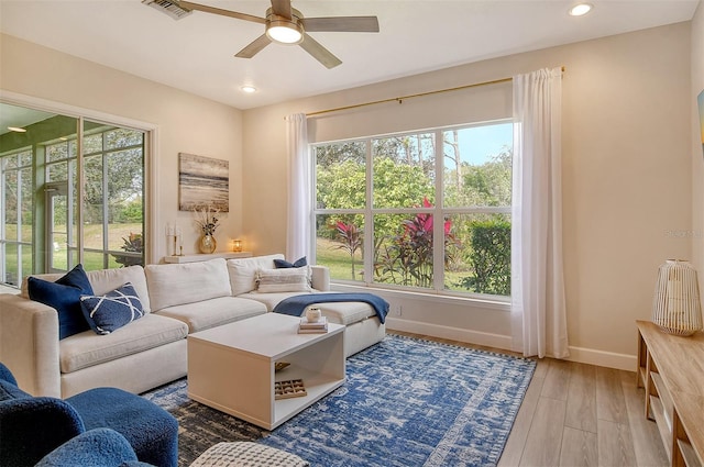 living room with ceiling fan and wood-type flooring