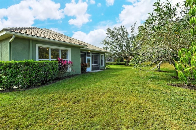 view of yard featuring a sunroom