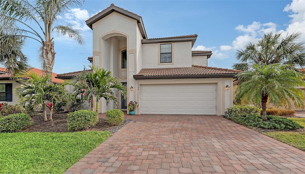 mediterranean / spanish-style home with a garage