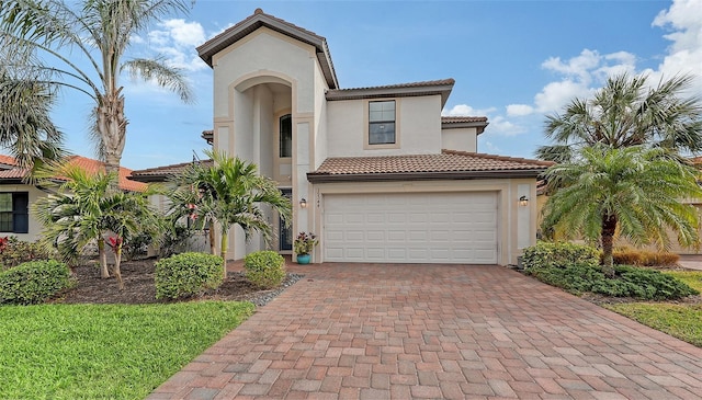 mediterranean / spanish-style home with a garage