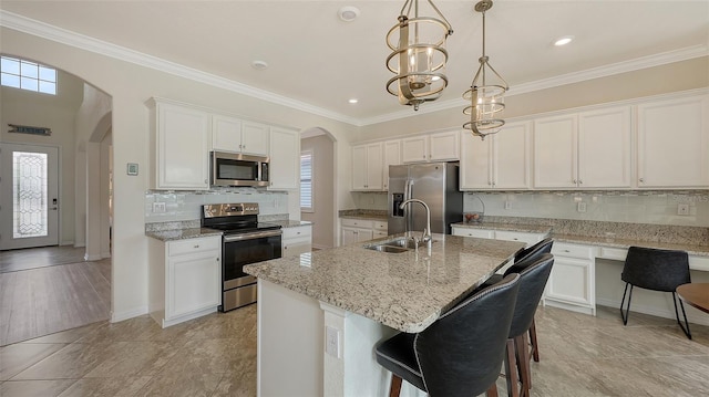 kitchen with sink, a center island with sink, white cabinetry, and appliances with stainless steel finishes