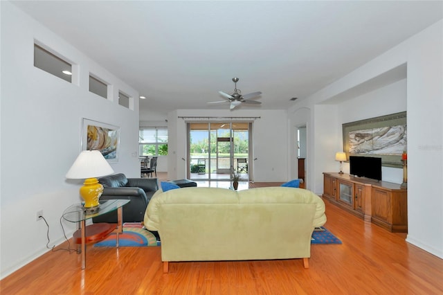 living room with light wood-type flooring and ceiling fan