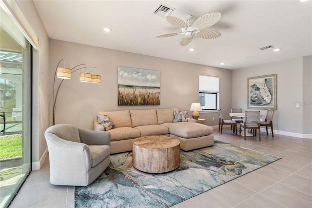 tiled living room featuring ceiling fan