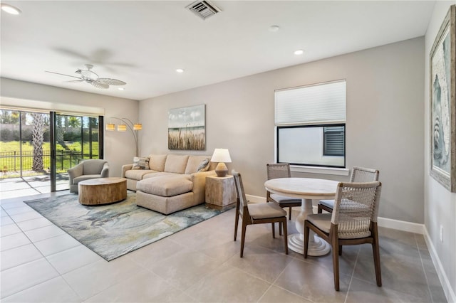 tiled living room with ceiling fan